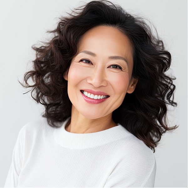 A cheerful and confident middle aged Asian woman with a beautiful smile showing her positive and joyful personality. | Dolce Vida Med Spa | Westport, CT | Trumbull, CT